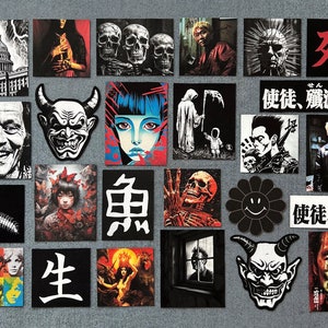 May include: A collection of 18 black and white stickers with various designs, including skulls, demons, a caterpillar, a building, a reaper, and Japanese characters. The stickers are arranged in a grid pattern on a gray surface.