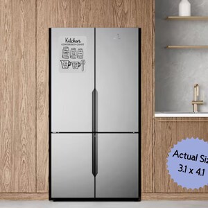 May include: A white kitchen conversion chart magnet, 3.1 x 4.1 inches, is affixed to a stainless steel refrigerator. The chart features black line drawings of measuring cups, spoons, and other kitchen tools, with the words "Kitchen Conversion Chart" at the top.
