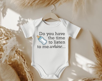 May include: White baby onesie with the text "Do you have the time to listen to me whine..." and a cartoon bottle graphic. The onesie is hanging on a wooden hanger against a neutral background.