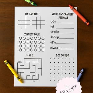 May include: A white activity sheet with various games, including Tic Tac Toe, Connect Four, a maze, and a dot-to-dot. The sheet also features a word scramble. Four crayons in green, orange, yellow, and blue are scattered around the sheet.