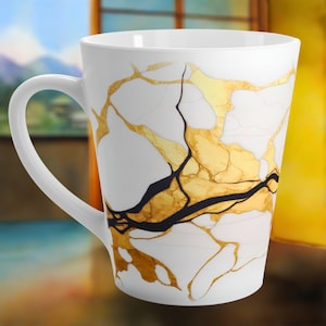 May include: White ceramic mug with a gold and black marbled design. The mug has a tall, tapered shape and a large handle.
