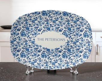 May include: A white oval serving platter with a blue and white floral pattern. The platter has a cream-colored oval in the center with the text "THE PETERSONS" printed in black.
