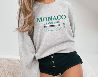 May include: Gray sweatshirt with a green graphic print that says "Monaco Grand Prix 19 Racing Club 29" with a checkered flag design.