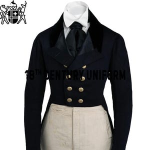 May include: A navy blue 18th-century uniform jacket with gold buttons, a black collar, and a white collared shirt. The text "18th CENTURY UNIFORM" is printed on the jacket. The jacket is paired with light tan pants.