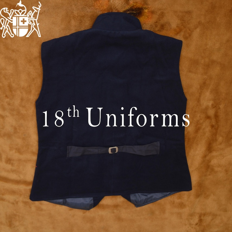 May include: A dark blue vest with a high collar and a belt with a silver buckle. The vest has a label that says "18th Uniforms".