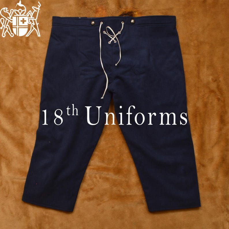 May include: Dark blue knee-length pants with a white drawstring and metal buttons. The pants are made of a thick, woven fabric. The text "18th Uniforms" is printed on the front of the pants.