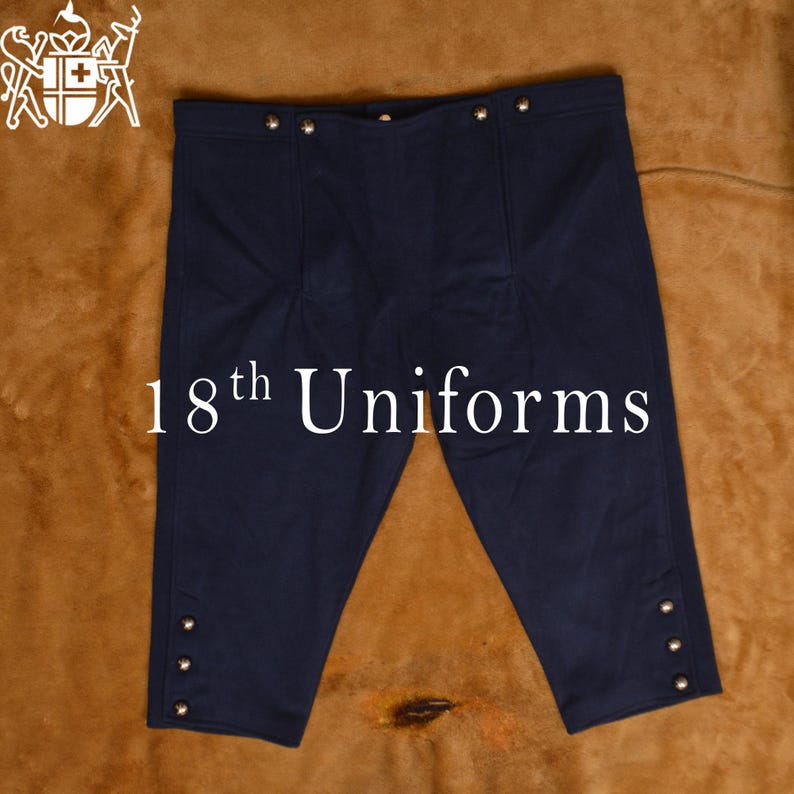 May include: A pair of dark blue knee-length pants with silver buttons. The pants are made of a thick, durable fabric and have a classic, timeless design. 18th Uniforms.