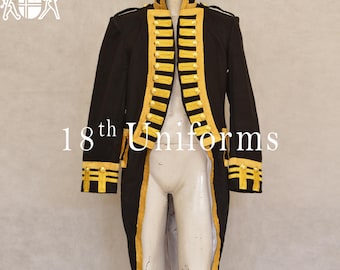 May include: A black military-style jacket with gold trim and a long tail. The jacket has a high collar and a row of buttons down the front. The jacket is on a mannequin.