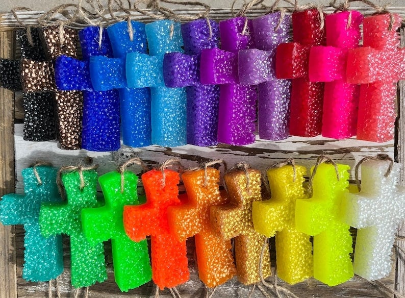 May include: A collection of 20 colorful cross-shaped air fresheners with a textured surface. The air fresheners are hanging from twine.