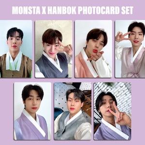 May include: A set of seven photocards featuring seven different members of the K-pop group MONSTA X. Each member is wearing a traditional Korean hanbok, a colorful and elegant garment. The photocards are part of a special photocard set.