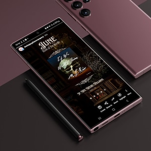 May include: A close-up of a smartphone screen displaying a book cover for "If We Were Villains" by M. L. Rio. The book cover features a skull with a dark background and a gold ornate frame. The screen also shows the book's rating and options to create, share, boost, highlight, and more.