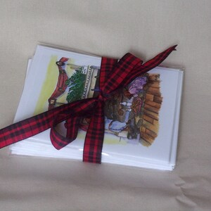 Doggy Christmas cards shown wrapped and tied with a plaid ribbon.