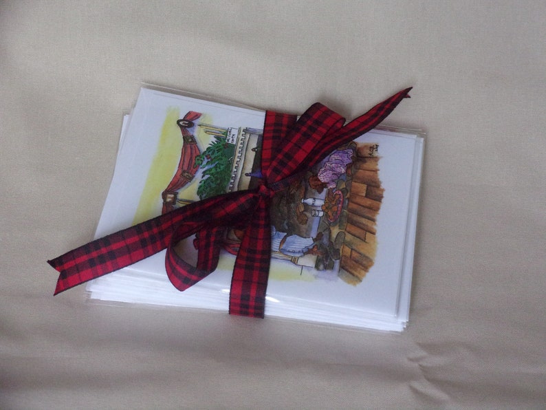 Doggy Christmas cards shown wrapped and tied with a plaid ribbon.