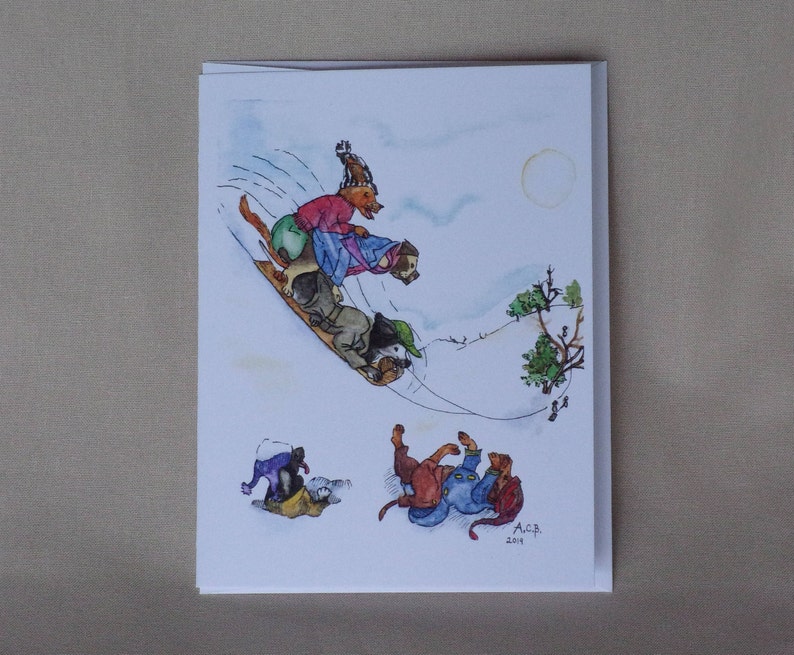 Three dogs are perched on a toboggan sled which is flying down a steep hill.  You can see treetops and other sledders at the bottom. It is a pale sunny day.  Two other dogs are stuck in the drifts and rolling around.  All wear scarves and funny caps.