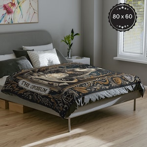 May include: A black and gold duvet cover featuring a vintage illustration of an opossum with the text "THE OPOSSUM". The duvet cover is displayed on a bed with grey bedding and pillows.