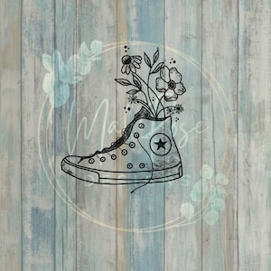 Puede incluir: Dibujo en blanco y negro de una zapatilla de caña alta con una estrella en el lateral. Las flores crecen desde la parte superior del zapato.
