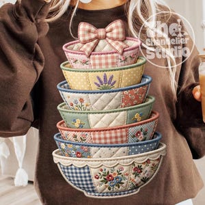 May include: A stack of six decorative bowls with floral and gingham patterns. The bowls are in various colors, including pink, yellow, green, and blue. The top bowl has a bow. The bowls are likely for decorative use.