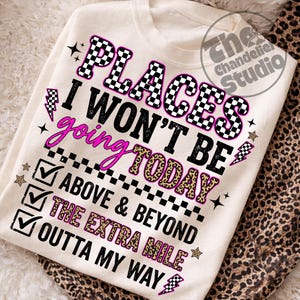 May include: Cream-colored sweatshirt with the text "PLACES I WON'T BE GOING TODAY" in black, pink, and leopard print. The design includes lightning bolts, stars, and checkmarks. The sweatshirt is folded on a leopard print fabric.