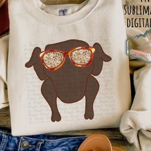 May include: A sublimation design featuring a brown cartoon turkey wearing orange and gold glitter sunglasses. The design is perfect for creating custom apparel, mugs, tote bags, and other items.