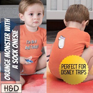 May include: Orange short-sleeved onesie with the text "I'm On A Roll Today!" on the front and a white sock with pink trim on the back. The onesie is perfect for a baby.