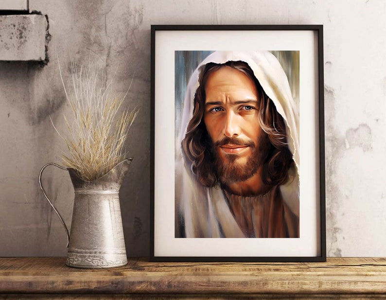May include: A framed painting of a man with long brown hair and a beard, wearing a white robe. He has a gentle expression and is looking directly at the viewer.