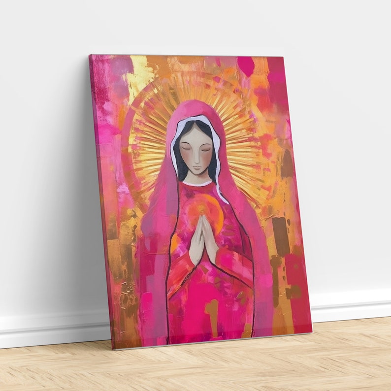 May include: A painting of a woman in a pink robe with a halo of light behind her. She is holding her hands together in prayer. The background is a mix of gold and pink.