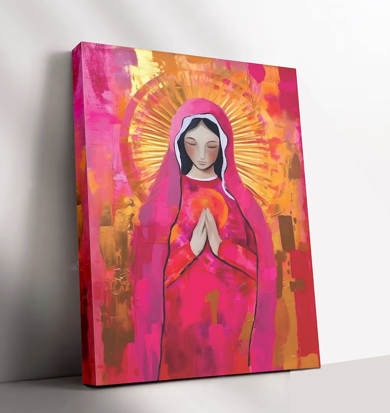 May include: A painting of a woman in a pink robe with a halo of light around her head. She is holding her hands together in prayer. The background is a mix of pink, gold, and orange.