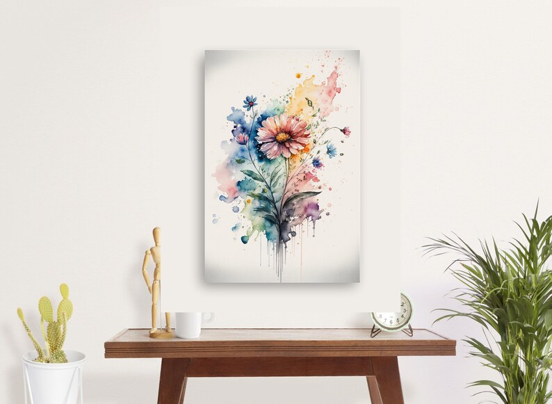 May include: Watercolor painting of a pink flower with blue and green leaves, surrounded by colorful watercolor splatters on a white background.