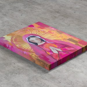 May include: A painting of a woman in a pink robe with a gold halo. The woman is praying with her hands clasped together. The background is a mix of yellow, orange, and pink.