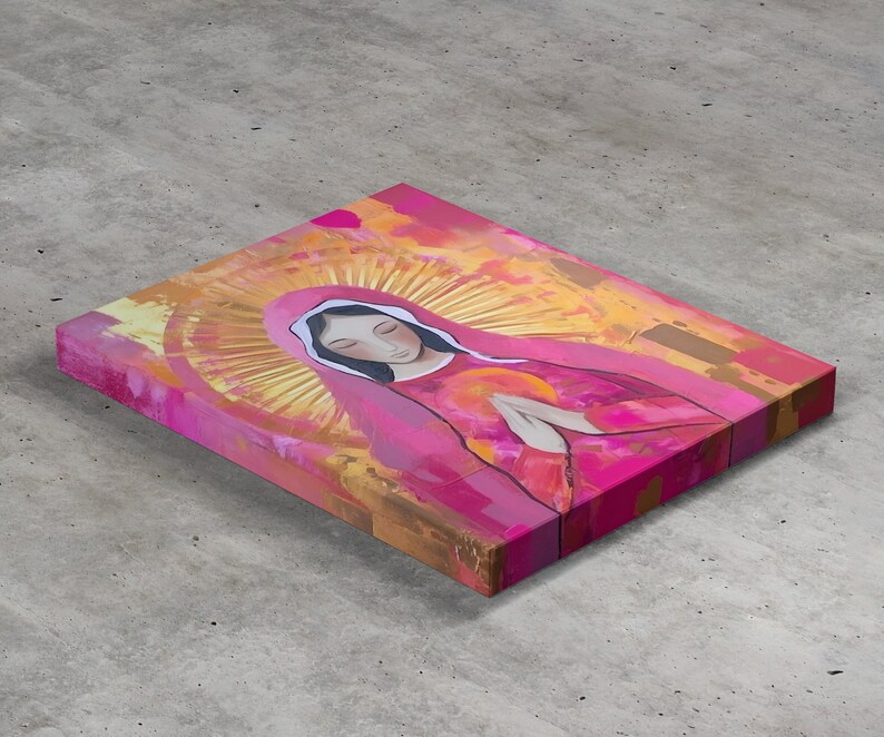 May include: A painting of a woman in a pink robe with a gold halo. The woman is praying with her hands clasped together. The background is a mix of yellow, orange, and pink.