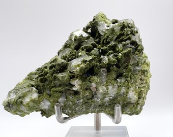 May include: A green and clear crystal cluster on a clear acrylic stand. The crystal cluster is a mix of green and clear crystals.