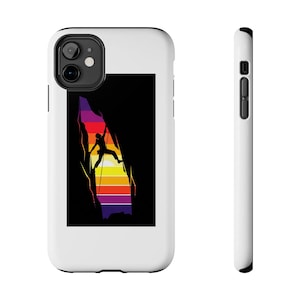 May include: White phone case featuring a graphic of a rock climber silhouetted against a colorful sunset. The climber is ascending a rock face, with a black background. The case has a sleek, modern design.