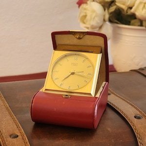 Very pretty travel alarm clock in leather case, from the Solo brand. Alarm clock, clock, pendulum.