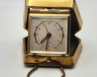 Travel alarm clock in the shape of a handbag. Alarm clock, clock, pendulum. Vintage clock, mechanical clock, mechanical alarm clock.