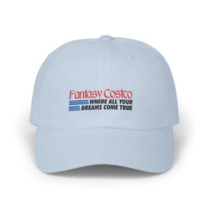 May include: A light blue baseball cap with the text "Fantasy Costco" in red and blue. The text "WHERE ALL YOUR DREAMS COME TRUE" is below the logo. The cap has a curved brim and a rounded crown.