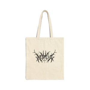 May include: A beige tote bag with black handles and a black graphic of the word "NEOPELIS" in a gothic font.