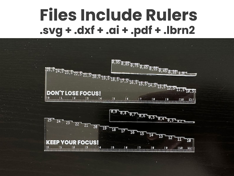 May include: Two clear plastic rulers with black markings and white text. The top ruler reads "DON'T LOSE FOCUS!" and the bottom ruler reads "KEEP YOUR FOCUS!"