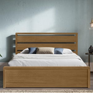 May include: A wooden bed frame with a slatted headboard. The bed is made of light brown wood and is set against a light blue wall. The bed has a white duvet and pillows. A side table and a plant are also in the room.