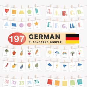 May include: A collection of 197 German flashcards, including shapes, letters, fruits, vegetables, colors, and numbers. The cards are strung on a line with small wooden clips. The words are in German.