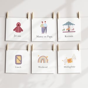 May include: A series of square cards hanging from a string with wooden clips. Each card features a different illustration and text. The illustrations include a coat, a couple, a carousel, a sandwich, a rainbow, and pillows. The text includes the words "Jas aan", "Mama en Papa", "Kermis", "Lunch", "Weekend", and "Middagdutje".
