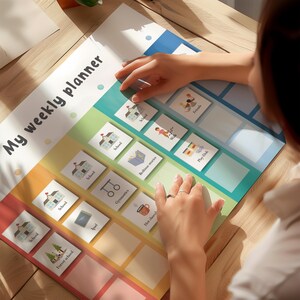 May include: A colorful weekly planner with the text "My weekly planner" at the top. The planner features illustrated activity cards for school, bedtime stories, and play. The planner is designed to help organize daily activities.