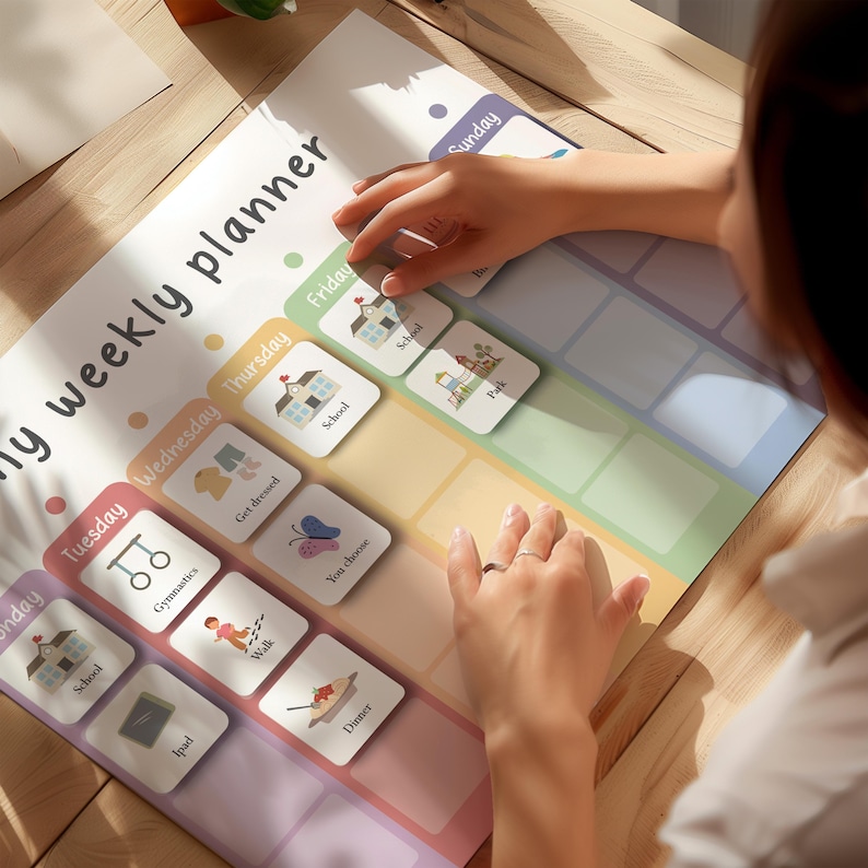 May include: A colorful weekly planner with the text "my weekly planner" and days of the week. The planner has illustrated activity cards for school, gymnastics, and dinner. A person is placing a card on the planner.