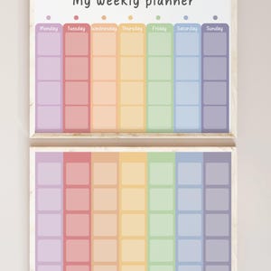 May include: Two framed weekly planners with a rainbow color scheme. Each planner has seven columns labeled Monday through Sunday. The text "My weekly planner" is at the top of the top planner.