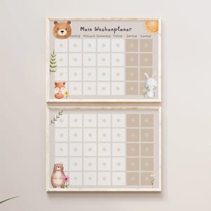 May include: Two framed weekly planners with a beige background and white squares. The top planner features a brown bear, a fox, and a sun. The bottom planner features a brown bear and a flower. The text "Mein Wochenplaner" is at the top of the planner.
