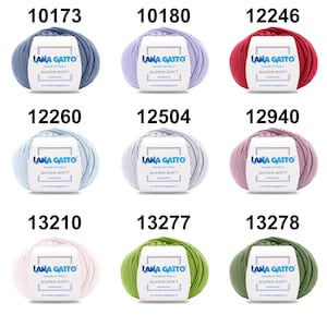 May include: Nine balls of yarn in various colors, including light blue, lavender, red, pink, green, and white. Each ball has a label that reads "Lana Gatto Made in Italy Super Soft" and a website address.