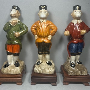 Vintage Monkey figurines set of 3  wooden base hand-painted porcelain monkey Solders Meissen hats 8”T  Excellent Condition!