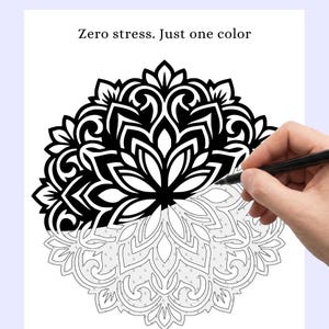 May include: Black and white mandala coloring page with the text "Zero stress. Just one color." A hand is holding a black pen and coloring the mandala. The mandala is partially colored in black.