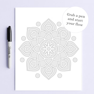 May include: A black Sharpie marker next to a grayscale mandala coloring page with a floral design and heart shapes. The text "Grab a pen and start your flow" is in a white circle.