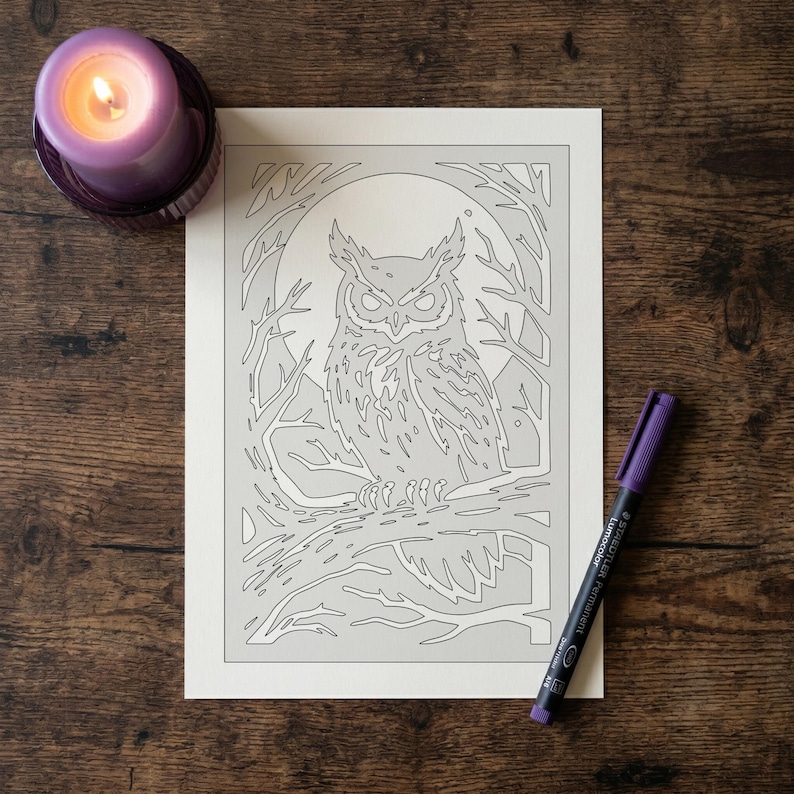 May include: A rectangular white paper sheet featuring a black line art illustration of an owl perched on a tree branch against a full moon background. A purple pillar candle and a purple permanent marker are positioned near the paper.