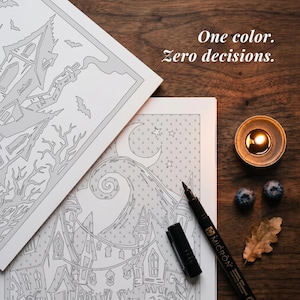 May include: Two white coloring pages featuring black line art of a haunted house and a swirling hill under a crescent moon. The text One color. Zero decisions. is printed above. A black Micron pen, a lit tea light candle, two blueberries, and a leaf.